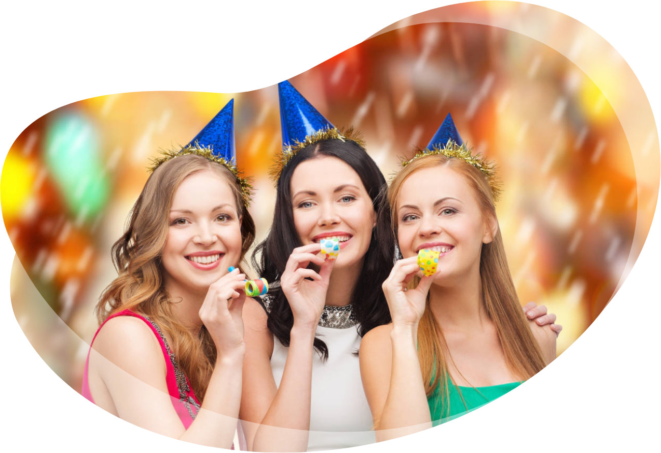 Three women at a party in a photo booth having fun.